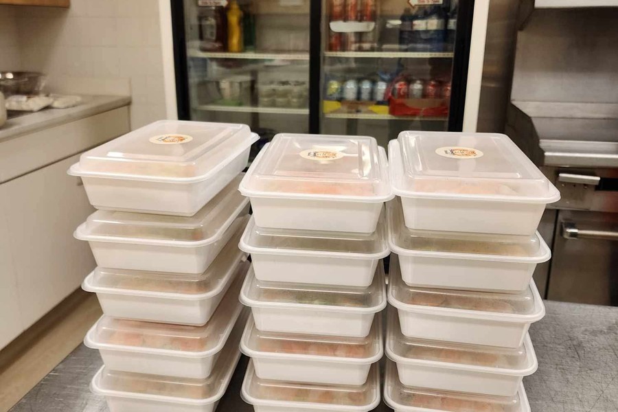 Hungry Thaiger 30 Stacked Hungry Thaiger takeout containers featuring custom branded stickers printed at Little Rock Printing.