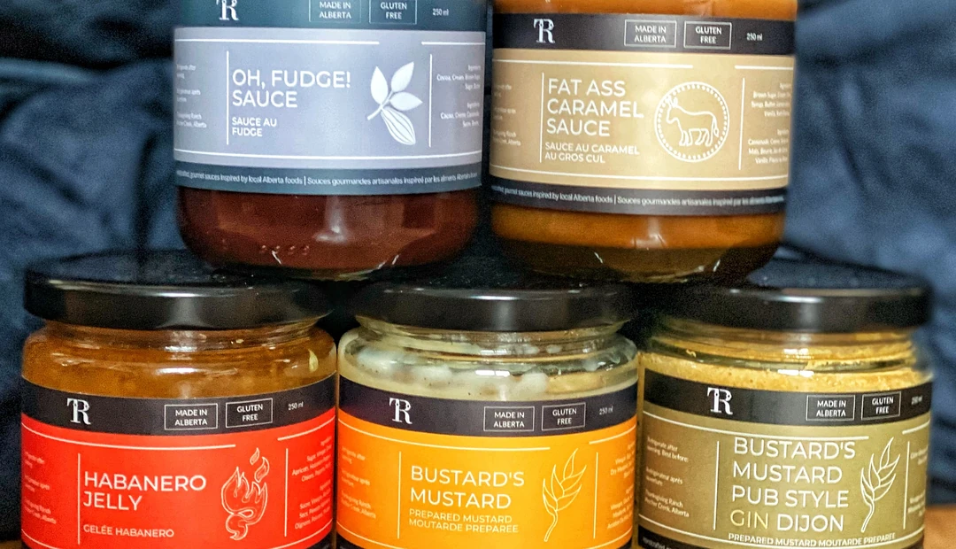 Colourful product labels on Alberta-made fudge sauce, caramel sauce, habanero jelly and mustard jars, printed at Little Rock Printing.